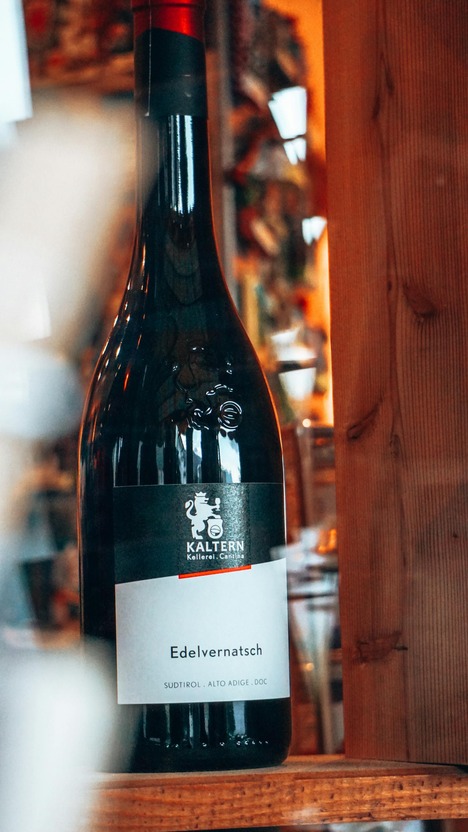 A library bottle of Vermora Reserva 2018, dusty in a stack of horizontal cellar bottles.